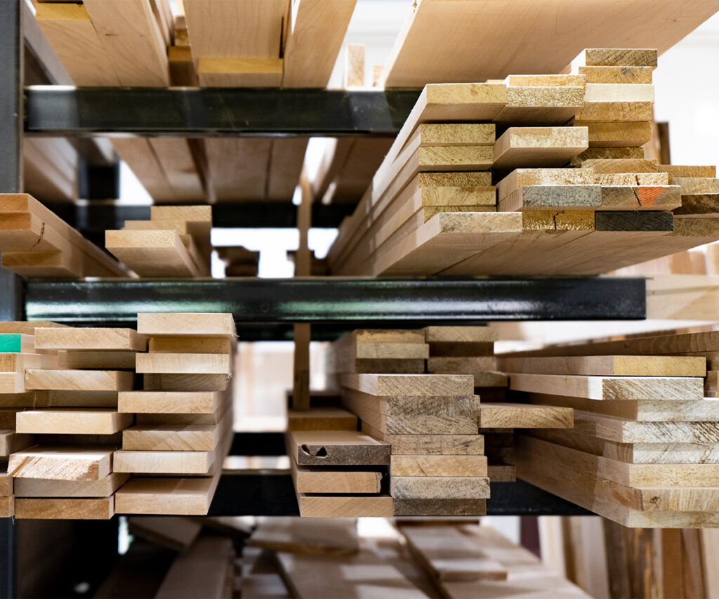 Stacks of hardwood lumber prepared for crafting, showing how Amish furniture is made.