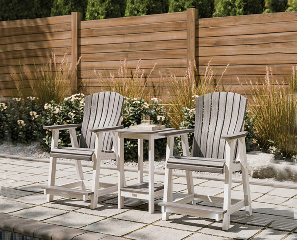 Two poly counter-height chairs with side table on sunny paver patio.