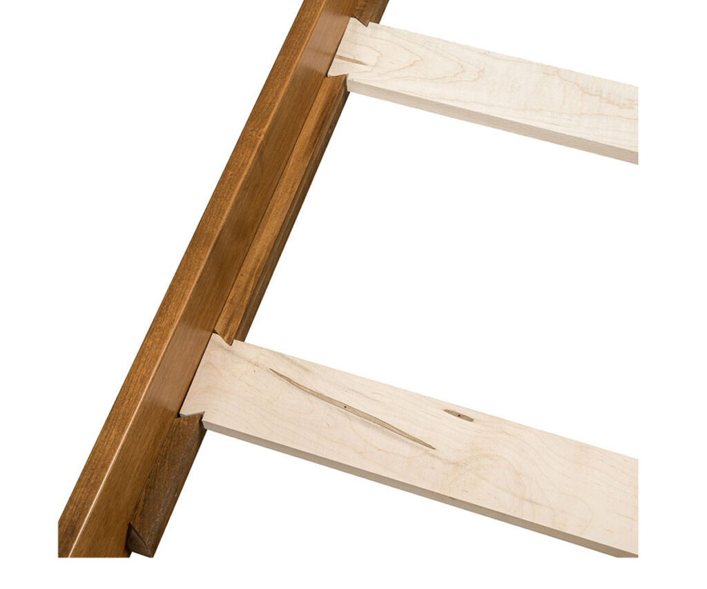 Close-up of dovetail bed-rail joint with interlocking wedge-shaped tenon and socket.