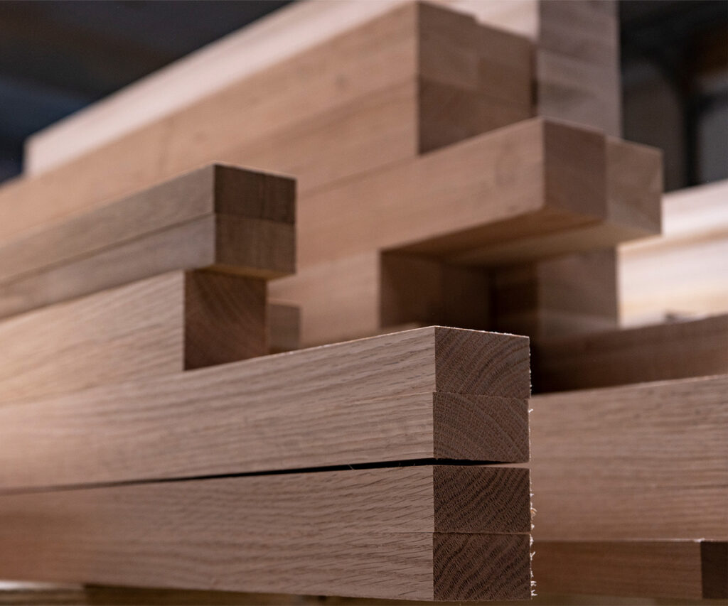 Stacked oak lumber boards in a mill, showing abundant, accessible American hardwood supply.