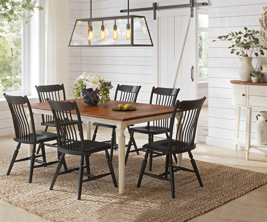 Dining room furniture with wood table, black chairs, and farmhouse-style dining space